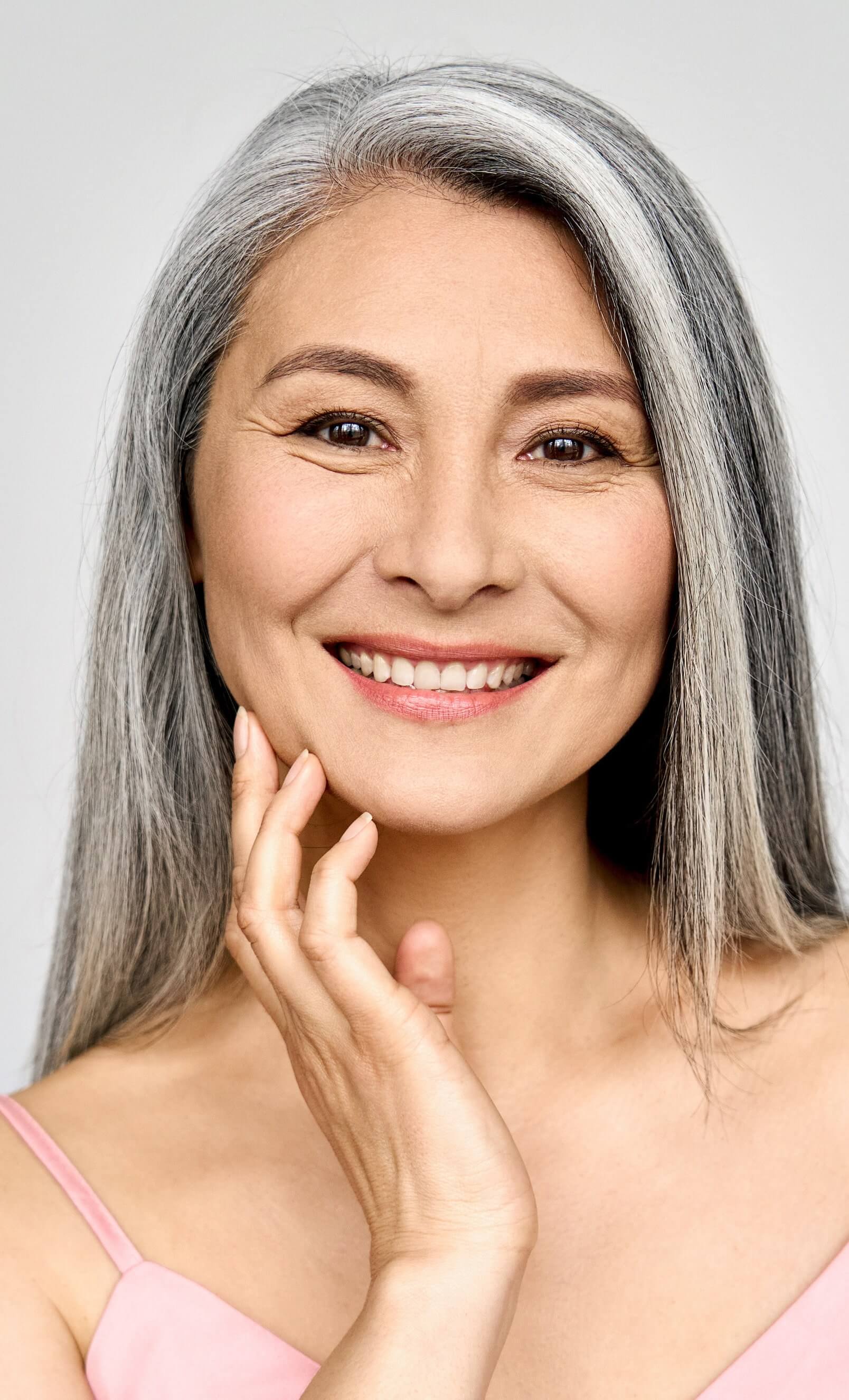 Photo of an older woman with graying hair and great skin
