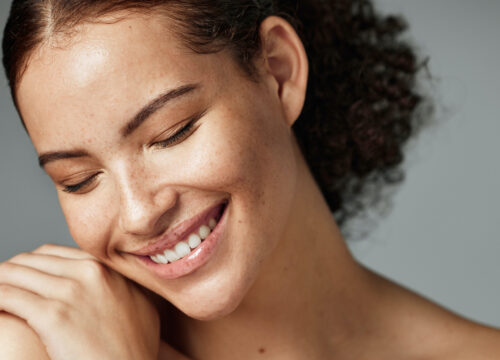 Photo of a woman with great skin and dark, curly hair